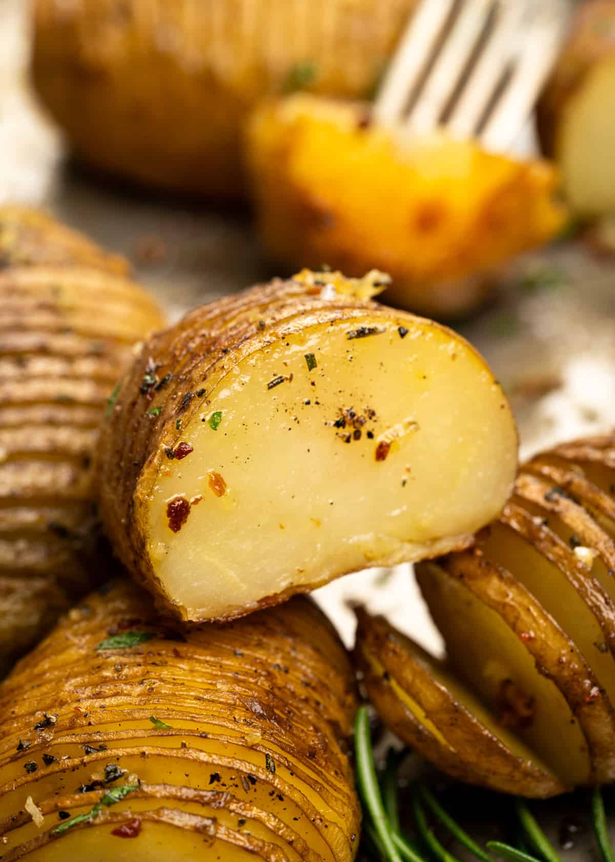 Hasselback Potatoes are a fun way to serve baked potatoes. Potatoes are sliced thin, flavoured with garlic rosemary butter, then baked until they are crispy on the outside and cooked perfectly on the inside. 