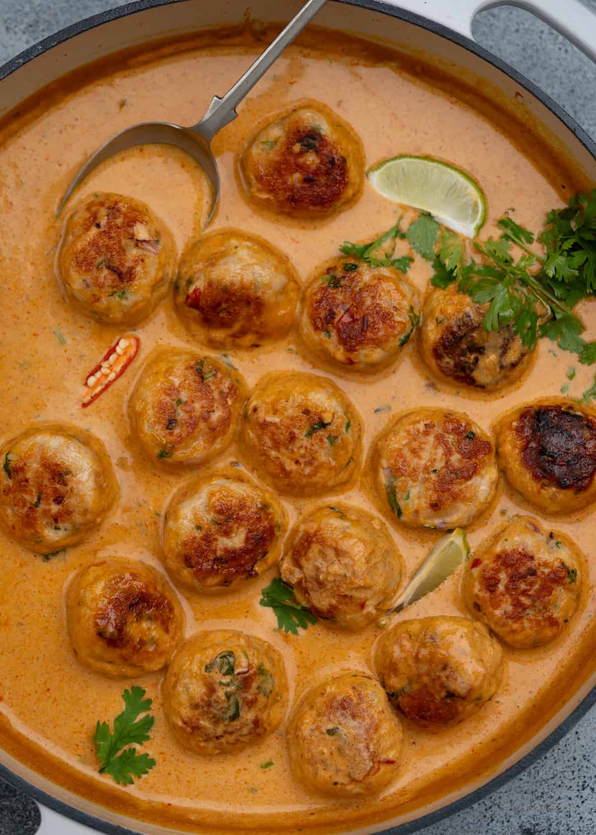 Chicken meatballs flavoured with fresh Thai herbs in a red curry sauce.