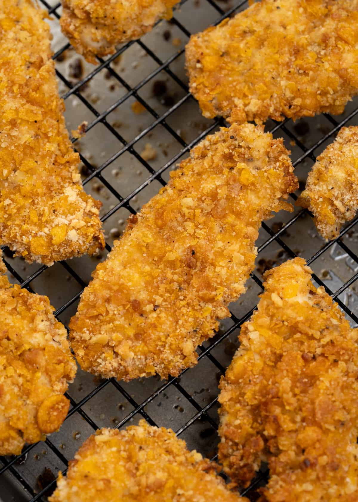 chicken breast strips marinated in seasoned buttermilk and coated with a crispy coating of cornflakes and crackers.