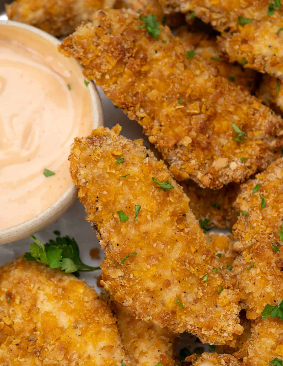 chicken breast strips marinated in seasoned buttermilk and coated with a crispy coating of cornflakes and crackers.