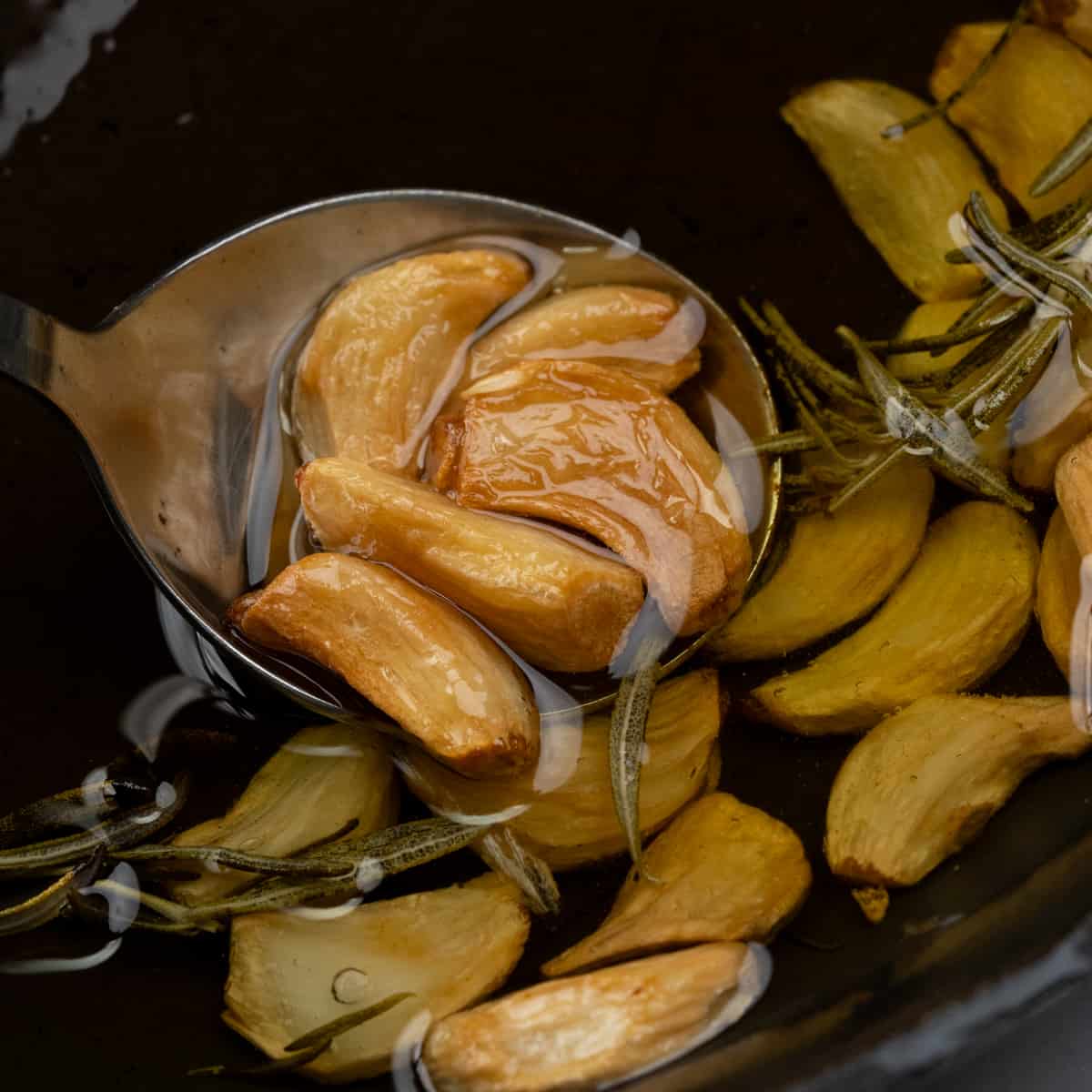 Slow roasted golden brown garlic cloves in olive oil. 