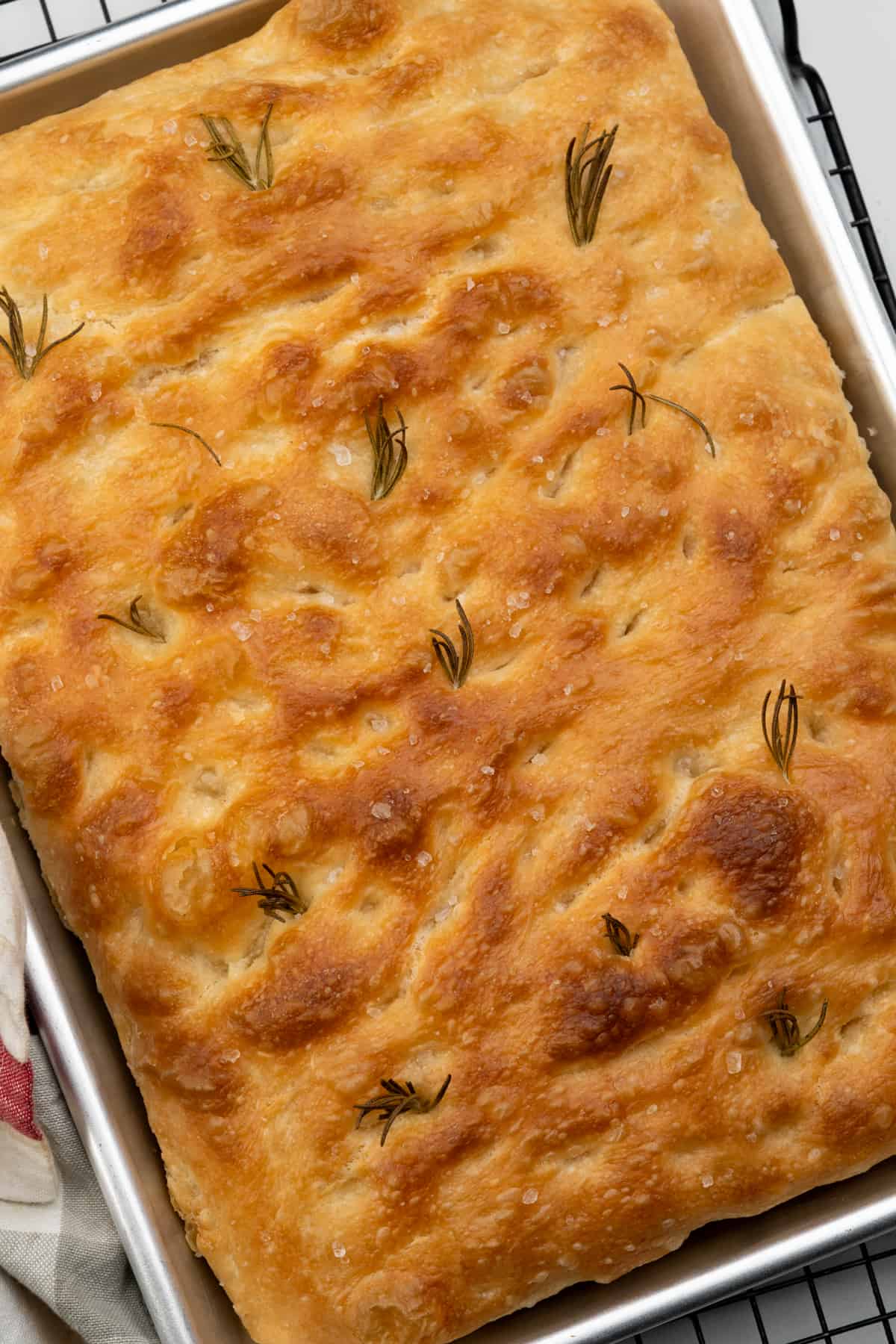Golden crust No knead focaccia bread with rosemary and flaky sea salt topping. 