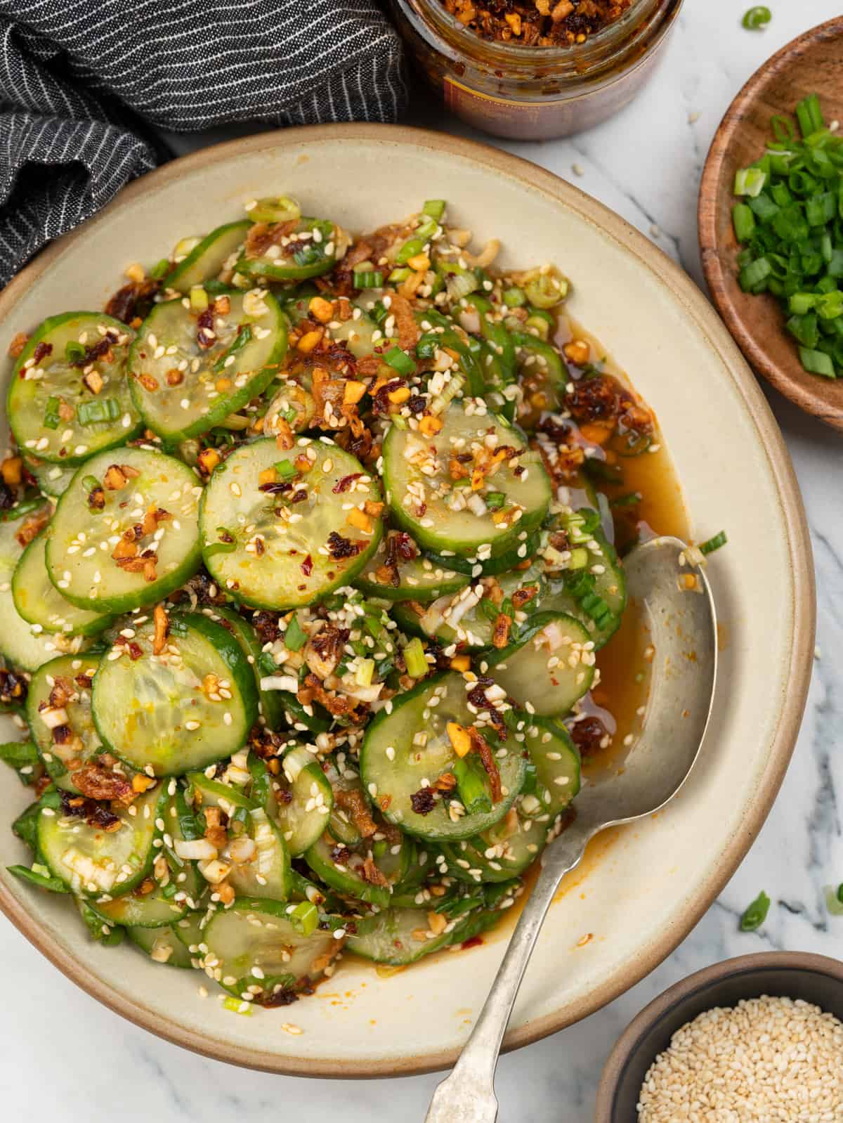 Sliced cucumbers, green onion tossed in a Asian inspired dressing, chilli crisp and toasted sesame seeds.