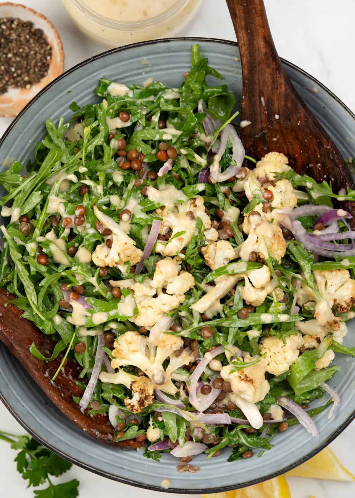 Roasted cauliflower salad with lentils, drizzled with tahini dressing