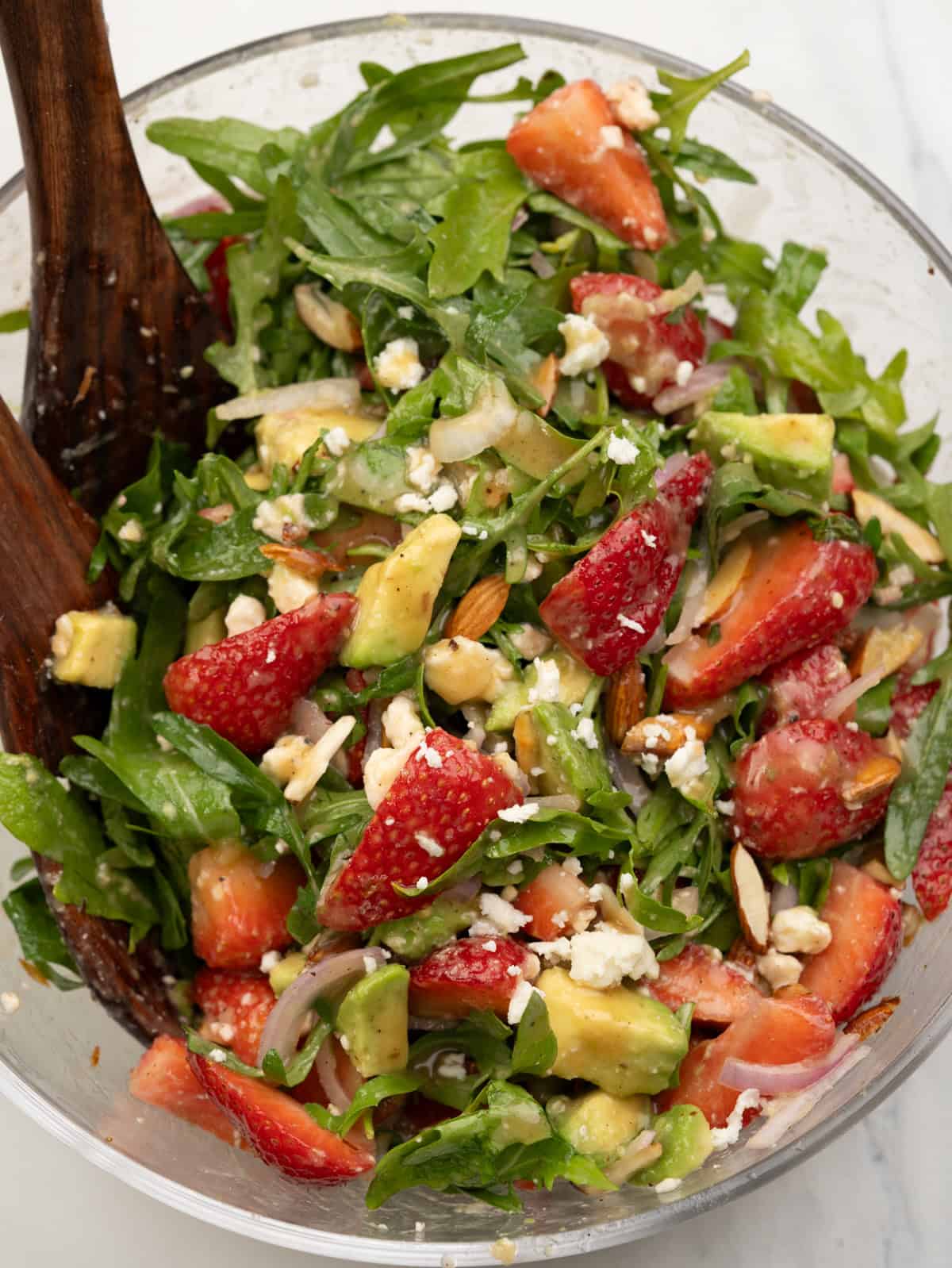 Strawberry salad with maple-dijon dressing, topped with toasted almonds and crumbled feta.