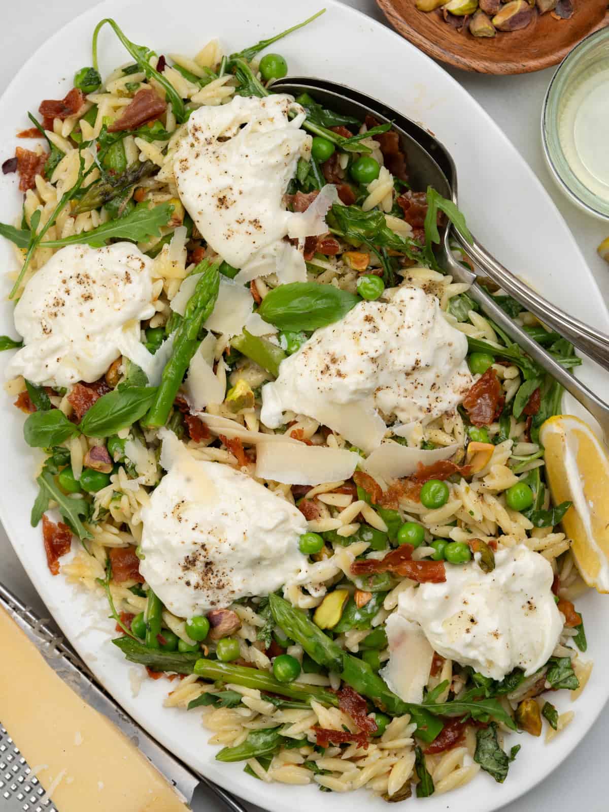 Orzo salad with spring vegetable, crispy prosciutto, pistachio dressed in EVVO, parmesan, fresh lemon juice. Topped with creamy burrata. 