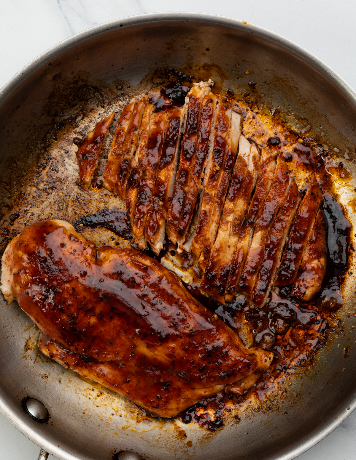 Brush seared chicken breast with bbq sauce.