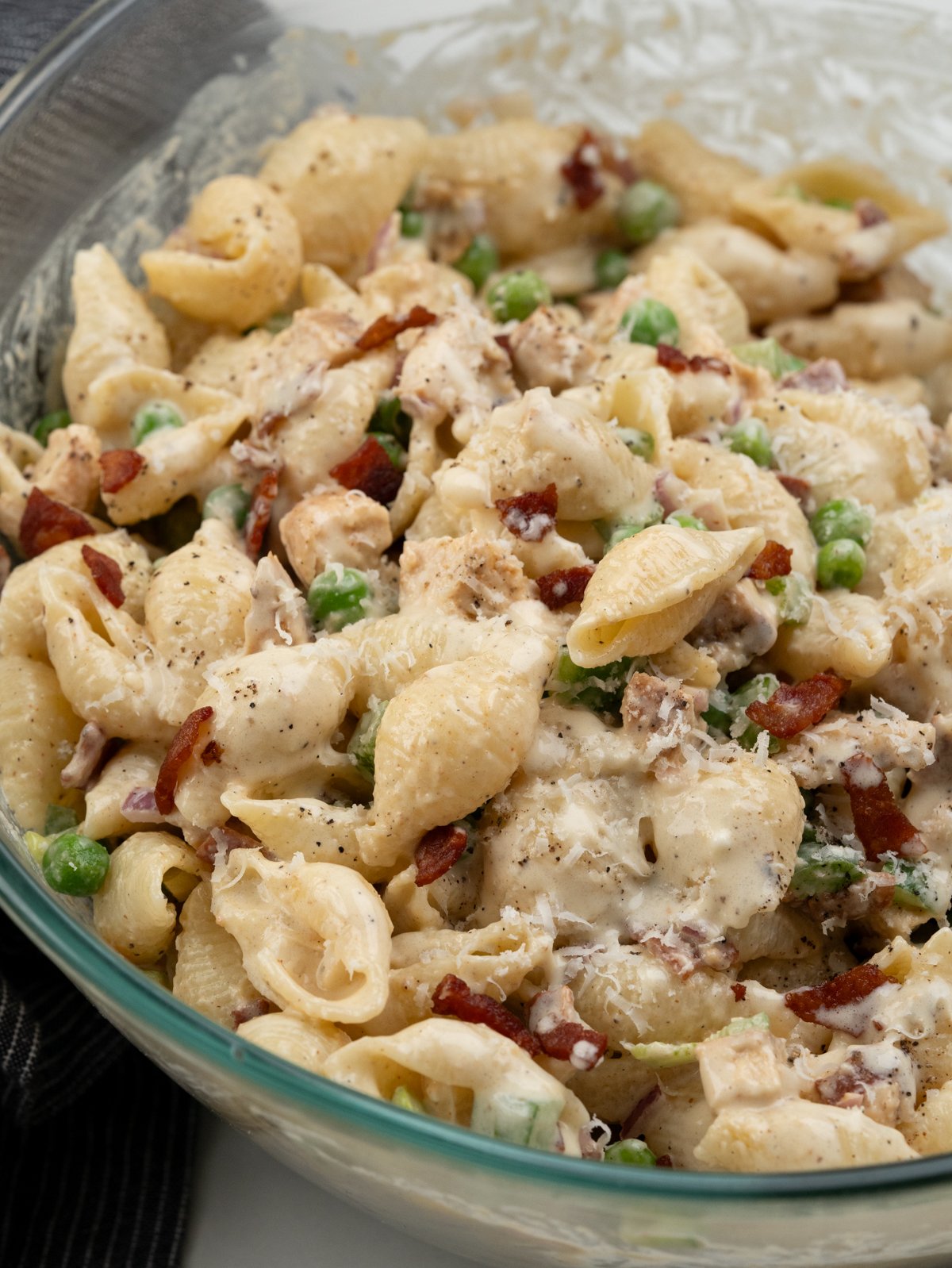 Shell pasta with diced grilled chicken, crispy bacon, peas, bell peppers, onion tossed in a mayo dressing. 