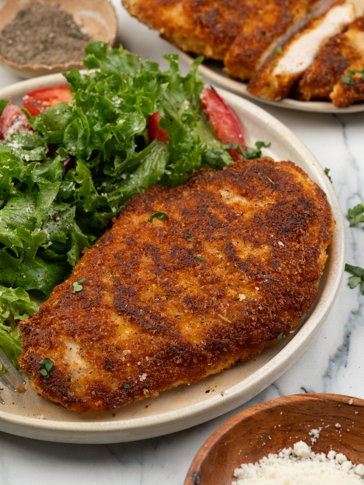 Chicken breast coated with a seasoned parmesan breading and pan fried until crispy. 