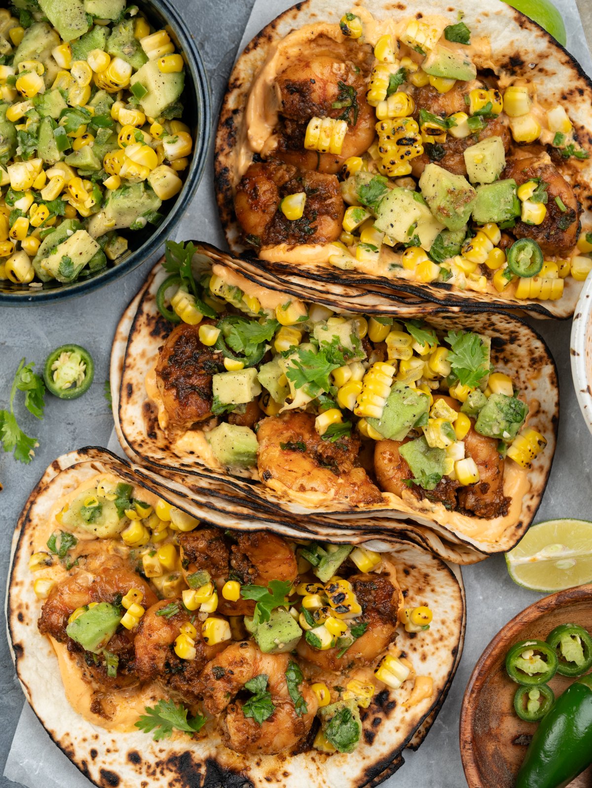 Shrimp tacos assembled and stacked next to each other.