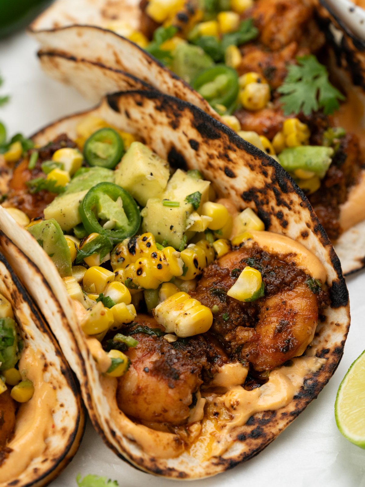 Grilled prawns, roast corn and avocado salsa piled high on a spicy mayo sauce on a warmed up tortilla.