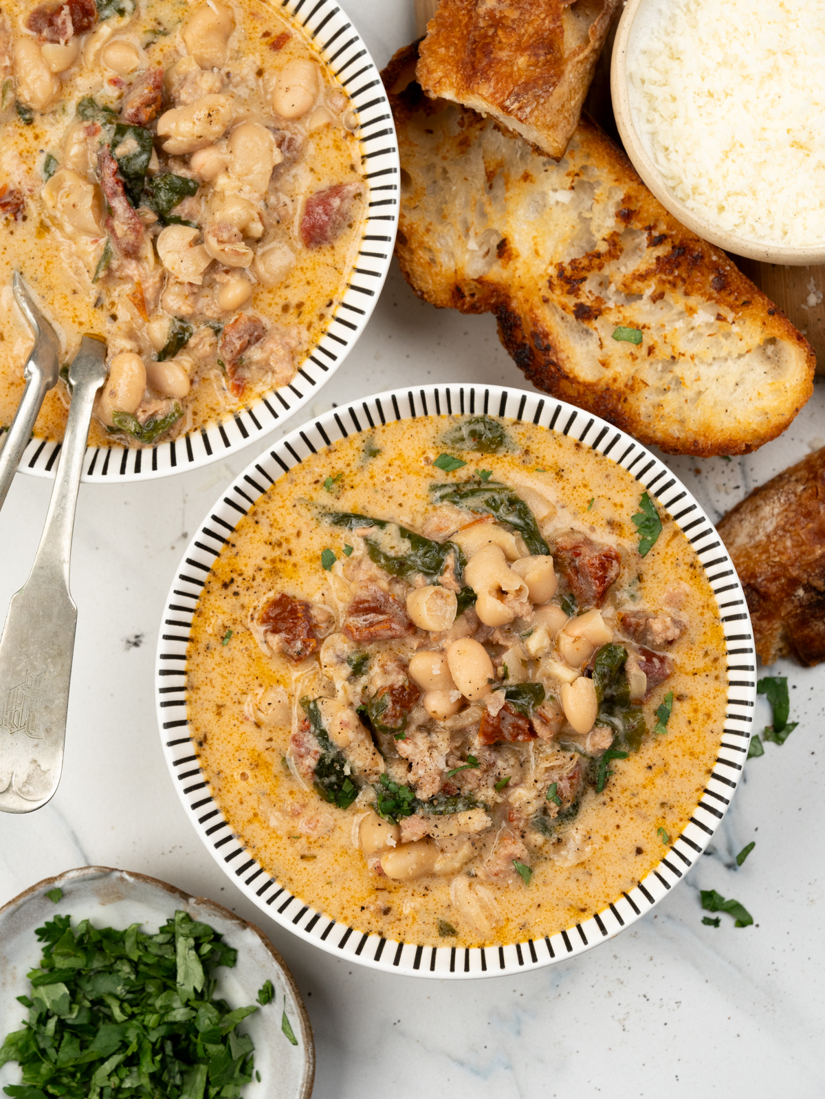 Bowl of creamy Italian Sausage Soup with white bean and spinach.