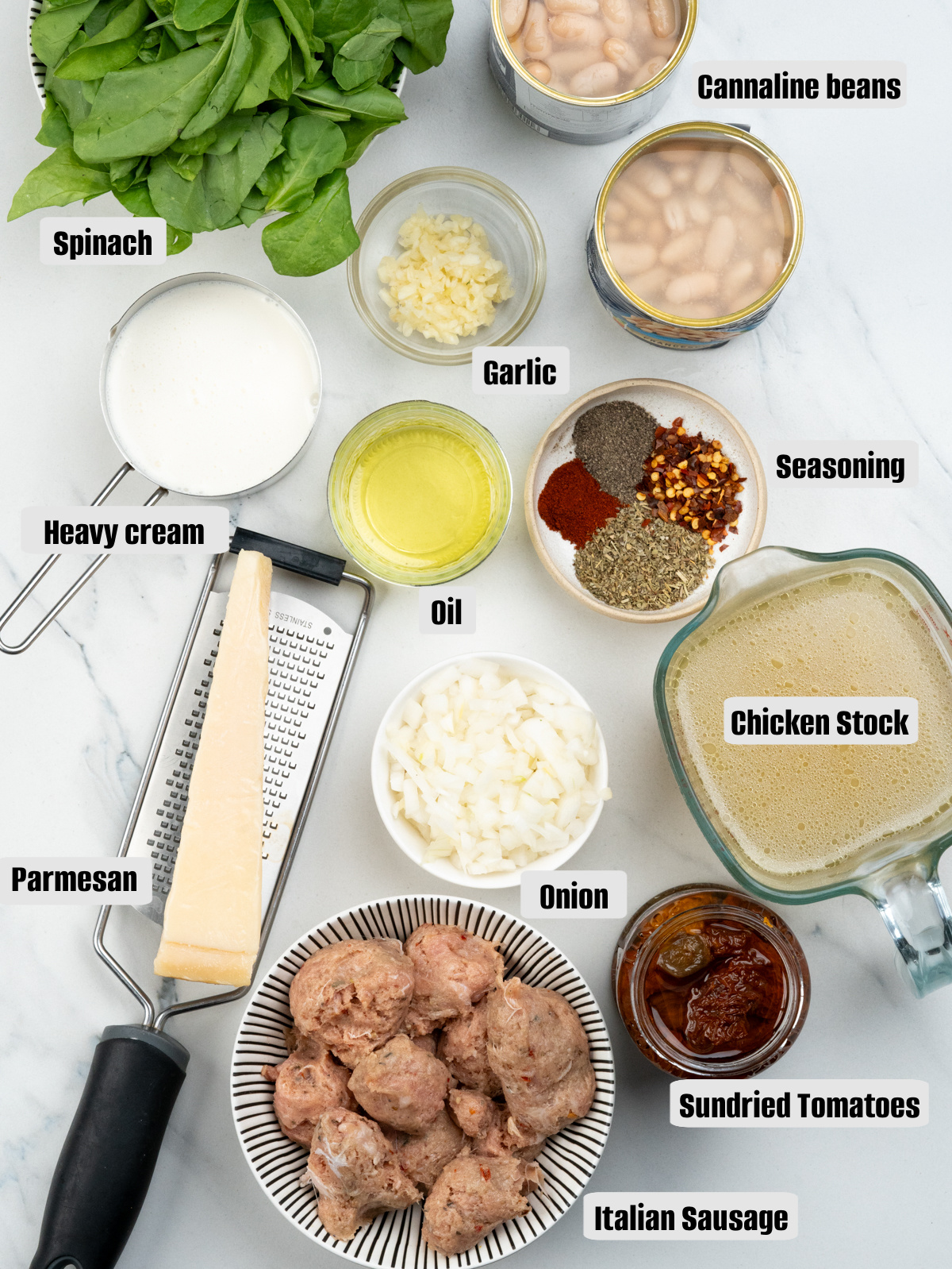 Ingredient list - Italian sausage, cannelini beans, chicken stock, aromatics, seasoning, heavy cream and parmesan.