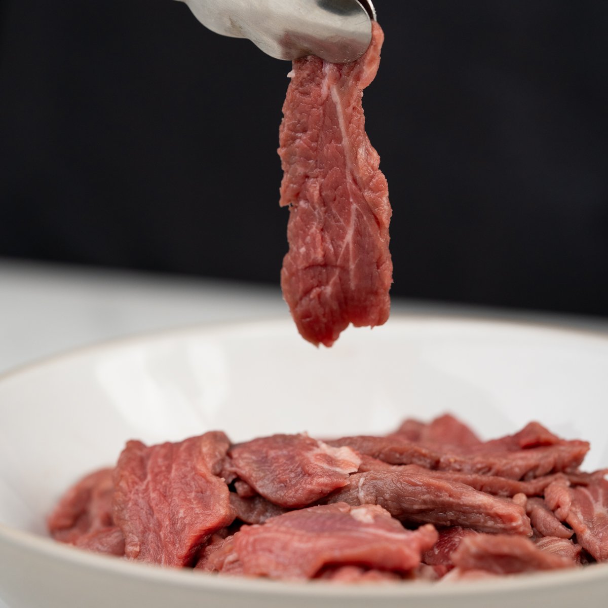 Cut flank steak against the grain and super thin. 