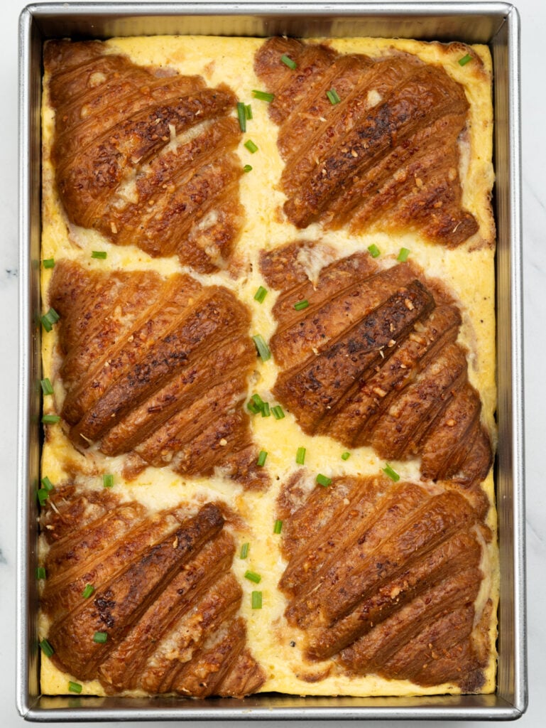 A croissant breakfast casserole brings together flaky crispy croissant and a casserole where the egg, milk, and cream bake into a custard like consistency. Easy to assemble and bake, this can also be prepped overnight.