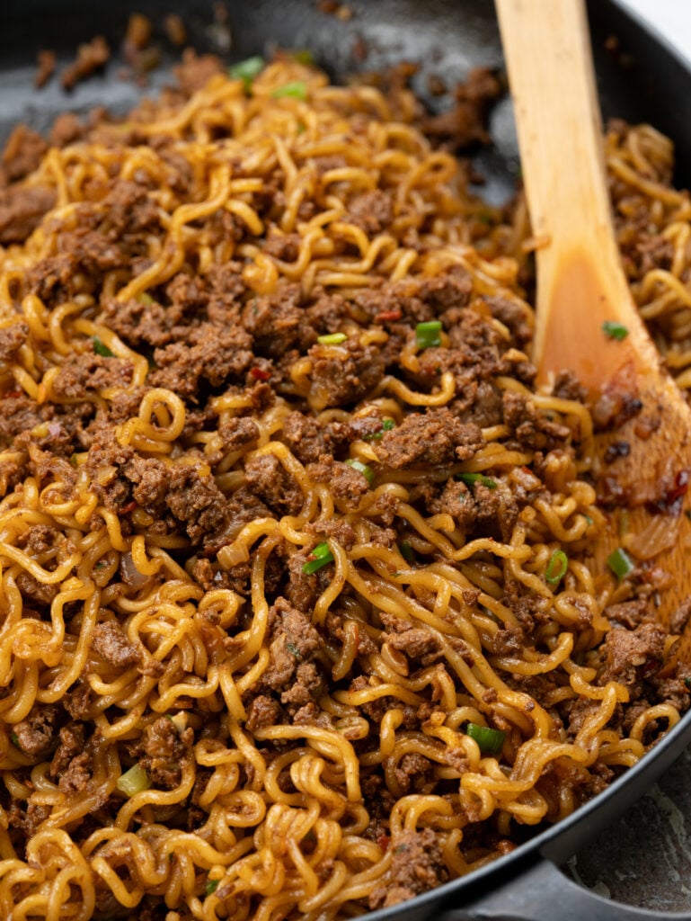 Asian Ramen noodle stir fry with ground beef. Topped with jammy egg and chilli crisp.