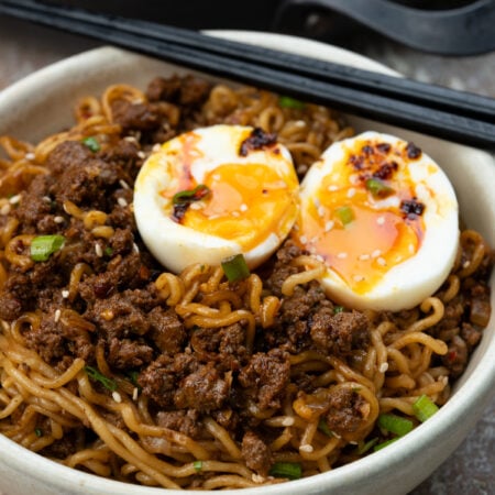 Asian Ramen noodle stir fry with ground beef. Topped with jammy egg and chilli crisp.