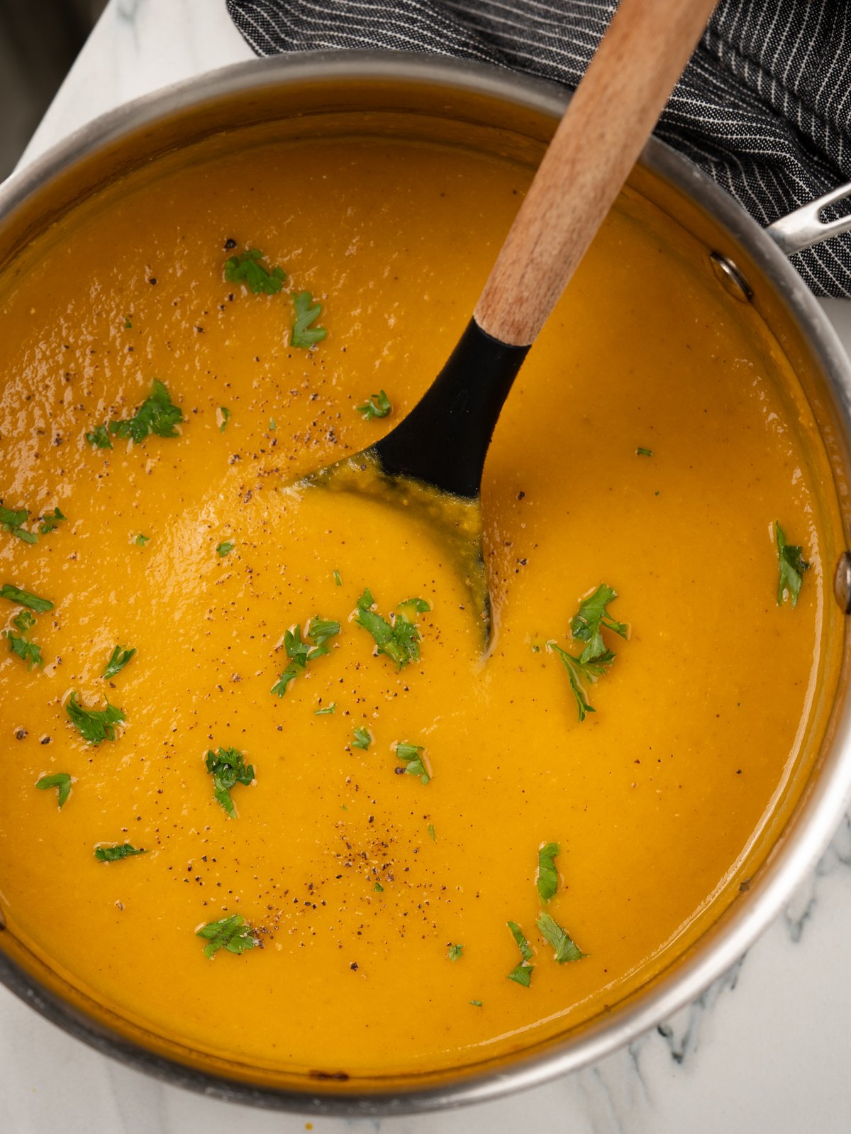 carrot ginger soup topped fresh parsley. 