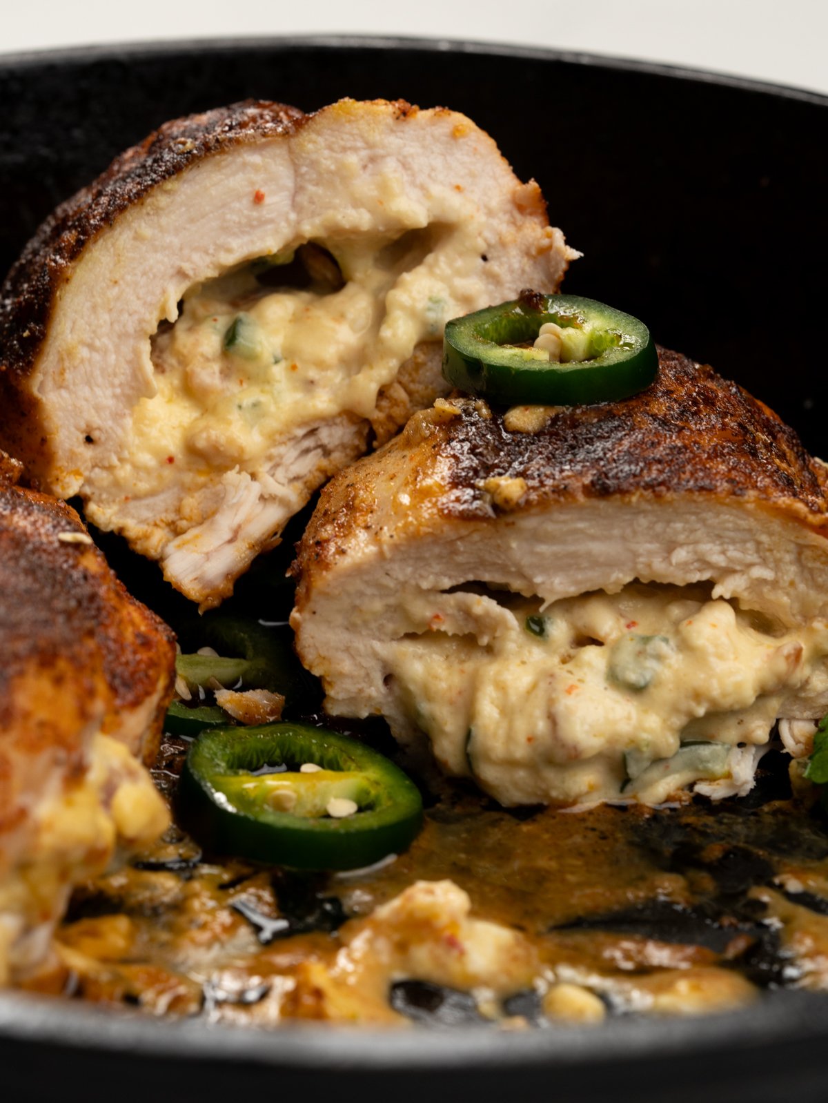 Half cut jalapeno popper stuffed chicken breast served with green salad