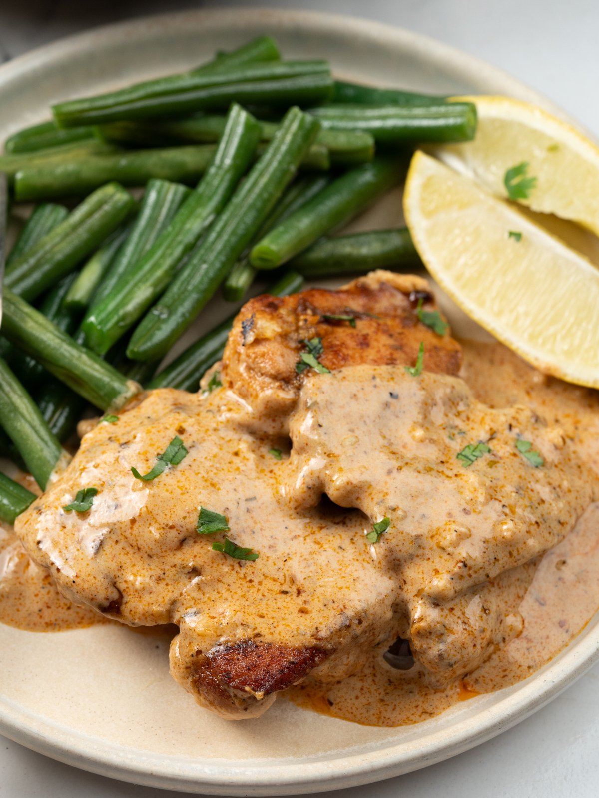 Chicken thighs topped with creamy cajun sauce, served with blistered green beans. 