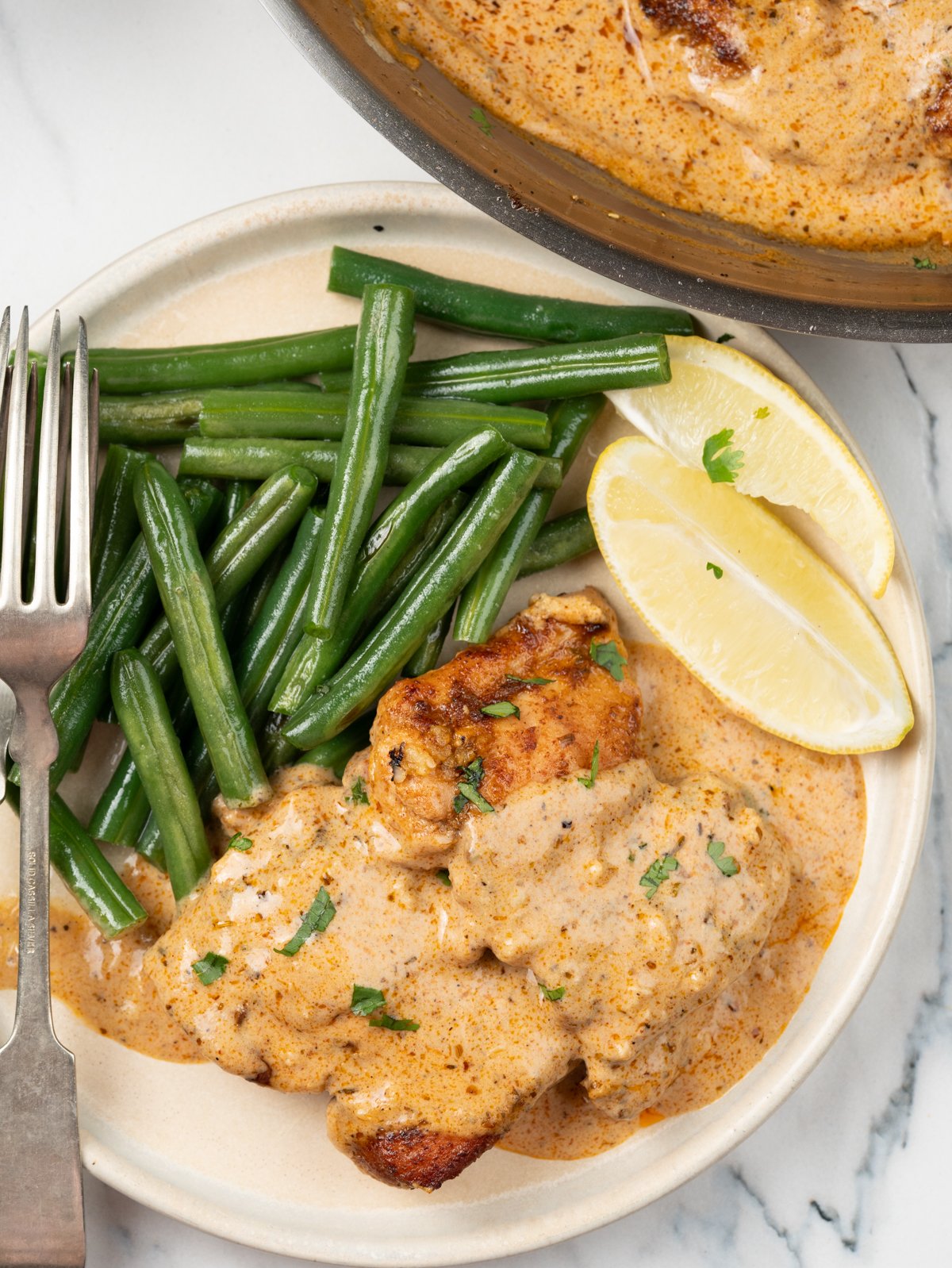 Chicken thighs topped with creamy cajun sauce, served with blistered green beans. 